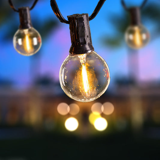 Close-up of illuminated garden string lights at dusk showing how to install solar garden lights