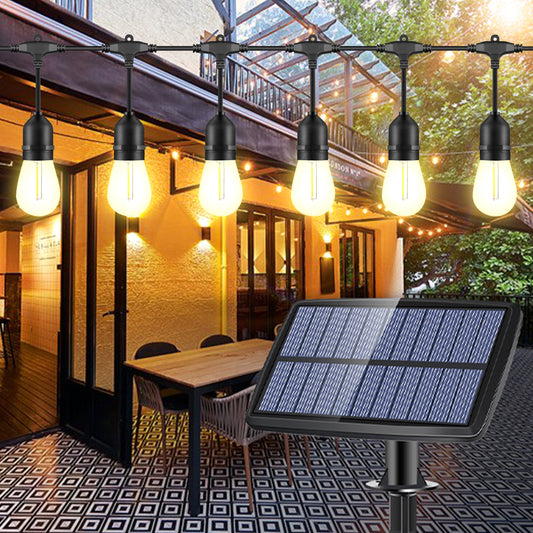 Solar string lights outdoor hanging above patio table with solar panel on tiled floor during evening