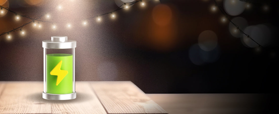 Illustration of a fully charged battery with string lights in the background comparing wired vs wire-free lighting