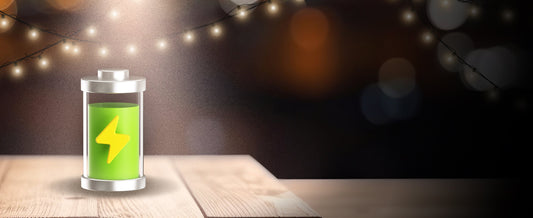 Illustration of a fully charged battery with string lights in the background comparing wired vs wire-free lighting