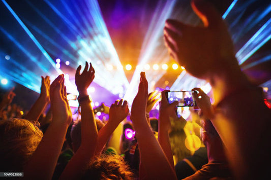 Crowd enjoying music at a concert with colorful outdoor smart lights with music sync illuminating the scene