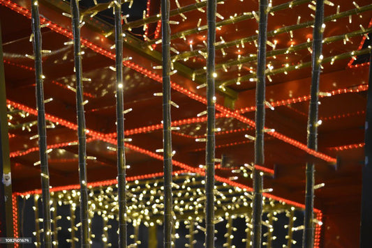 Decorative LED string lights 8 modes hanging vertically with warm white and red lights in a cozy setting