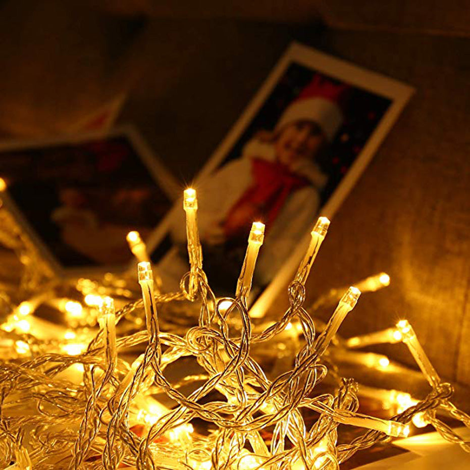 Warm white Battery String Lights glowing softly with tangled clear wires for indoor decoration