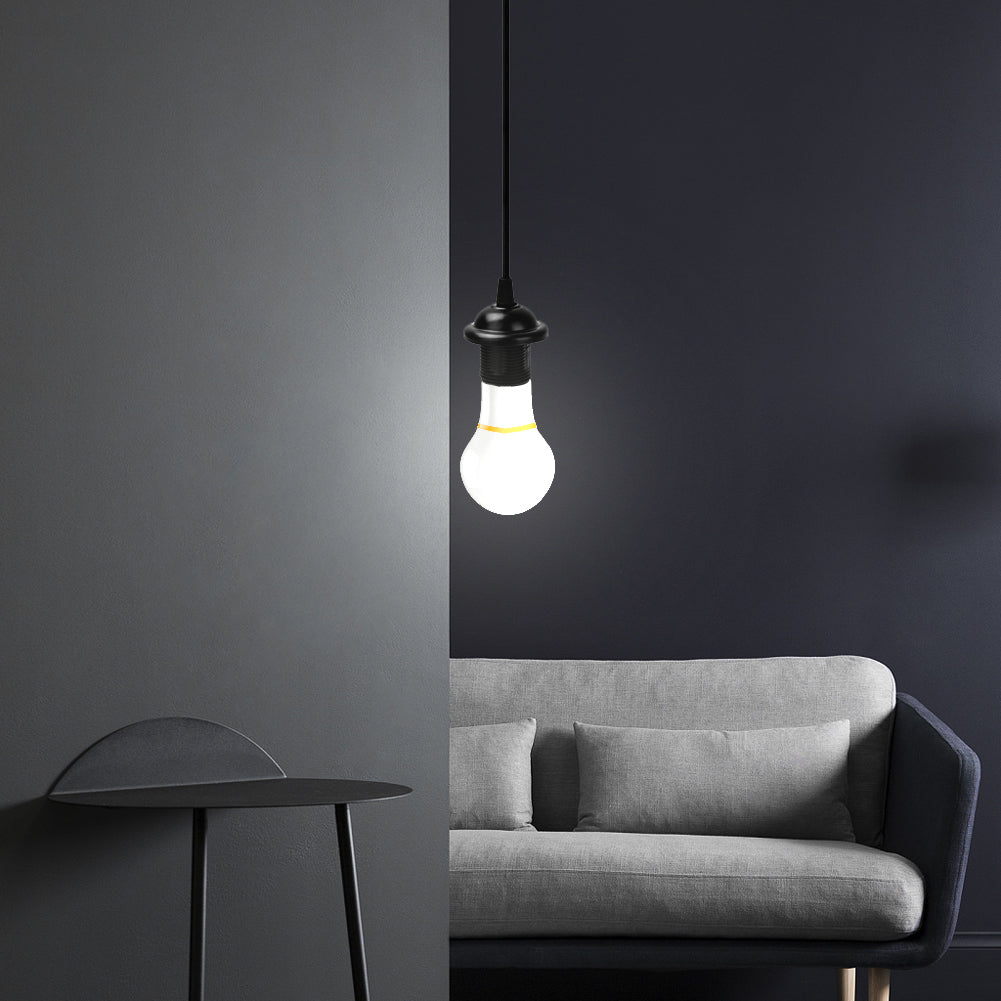 Modern black E27 lamp holder pendant light hanging over gray sofa in minimalist living room