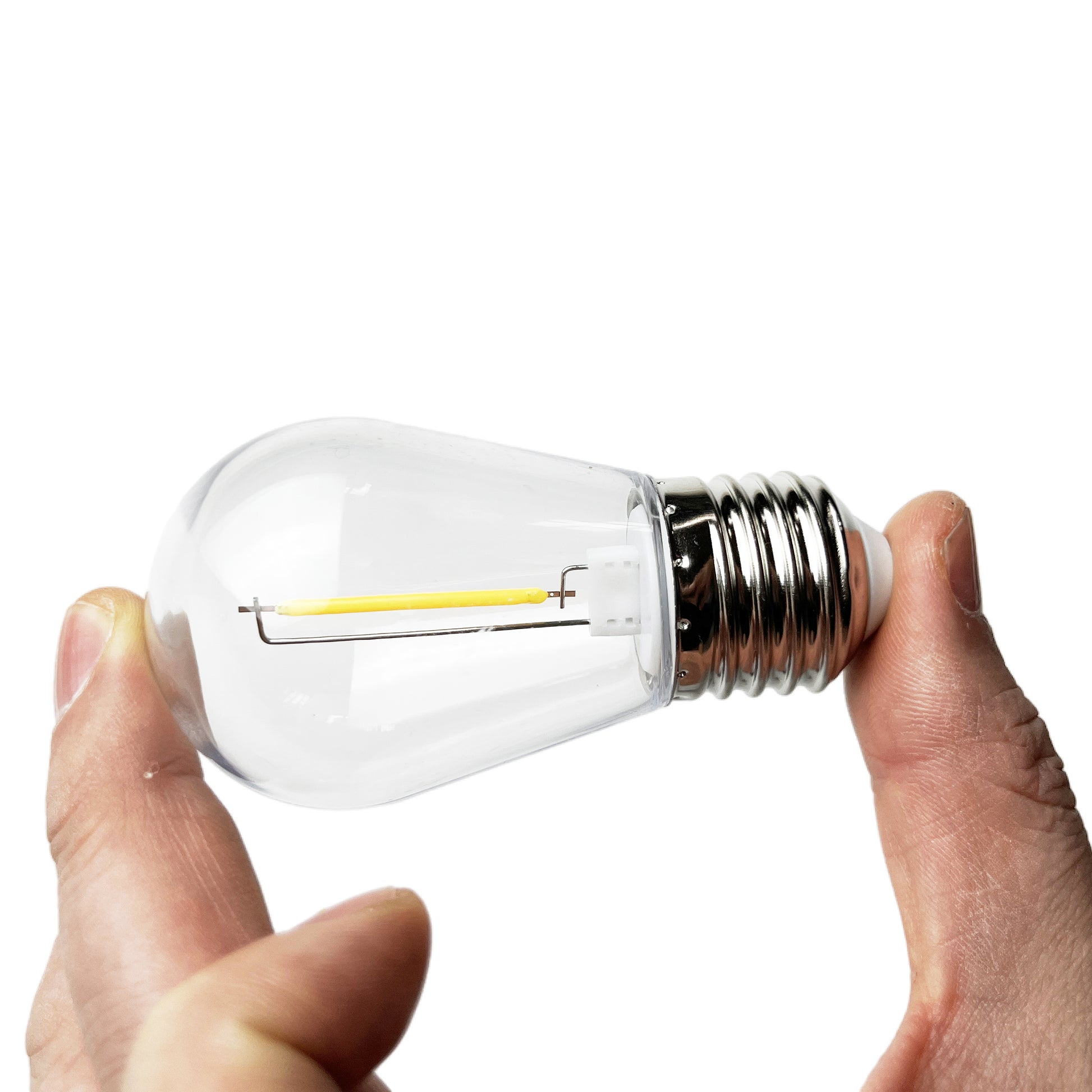 E27 LED outdoor bulb held between fingers showing clear glass and filament design