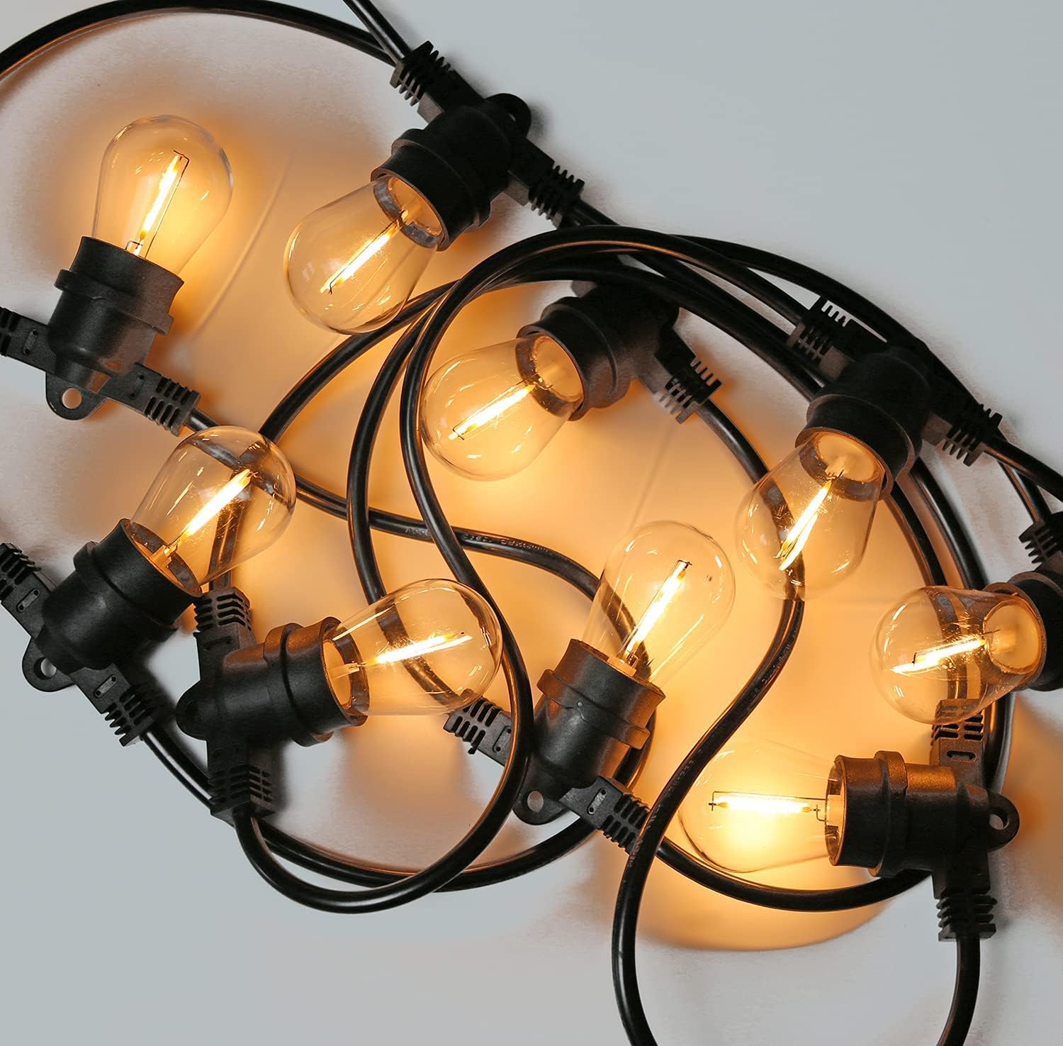 E27 LED outdoor bulb string lights with warm glowing bulbs and black wiring for outdoor use