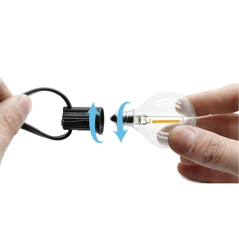 Hand holding G40 LED Bulb being screwed into black socket with arrows showing installation direction