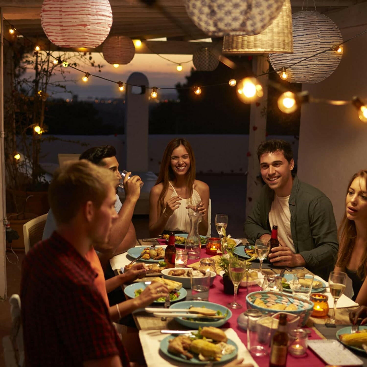 Outdoor dining area illuminated with warm led lights and decorative lanterns for gatherings