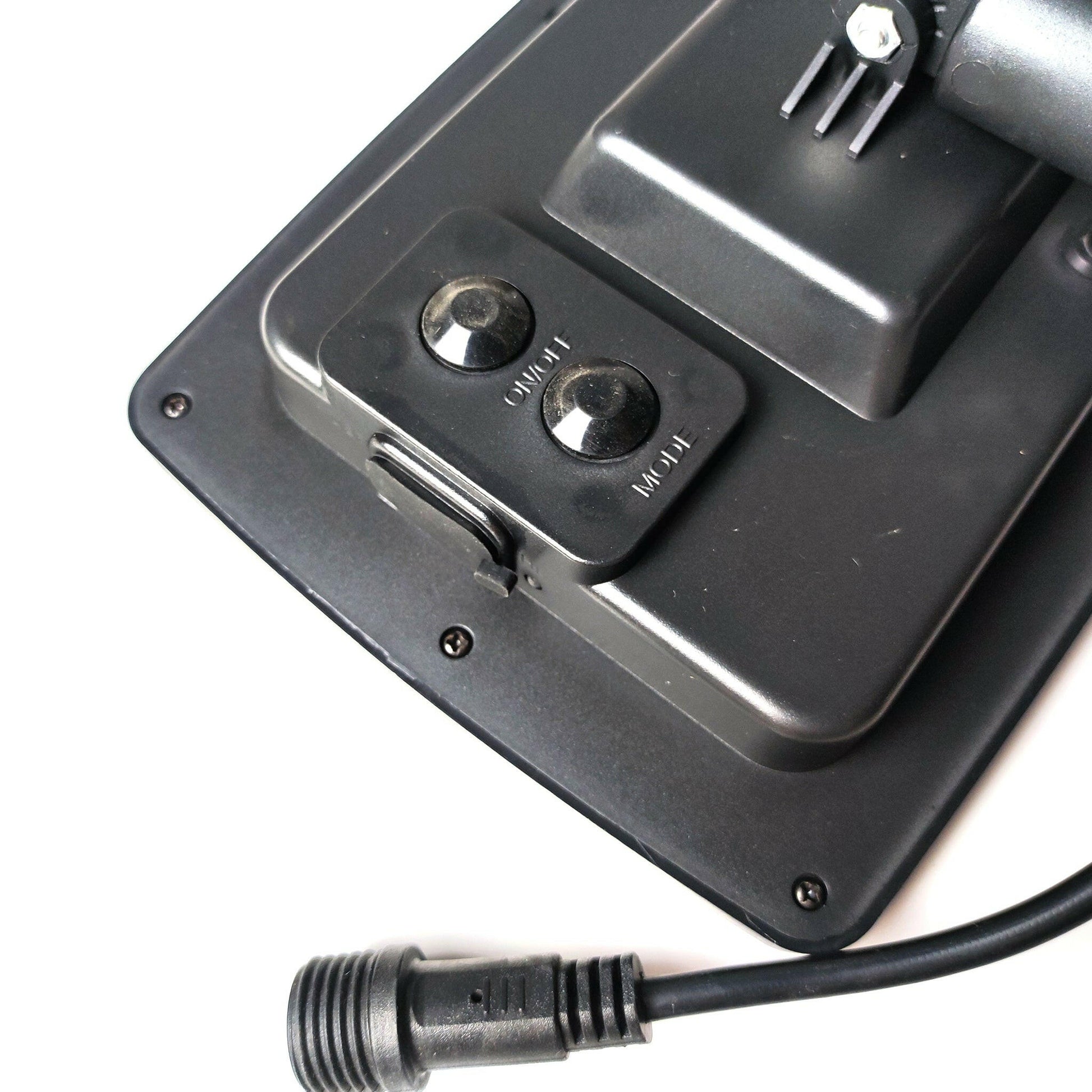 Close-up of black outdoor solar lights control panel with on off and high low switches and power cable