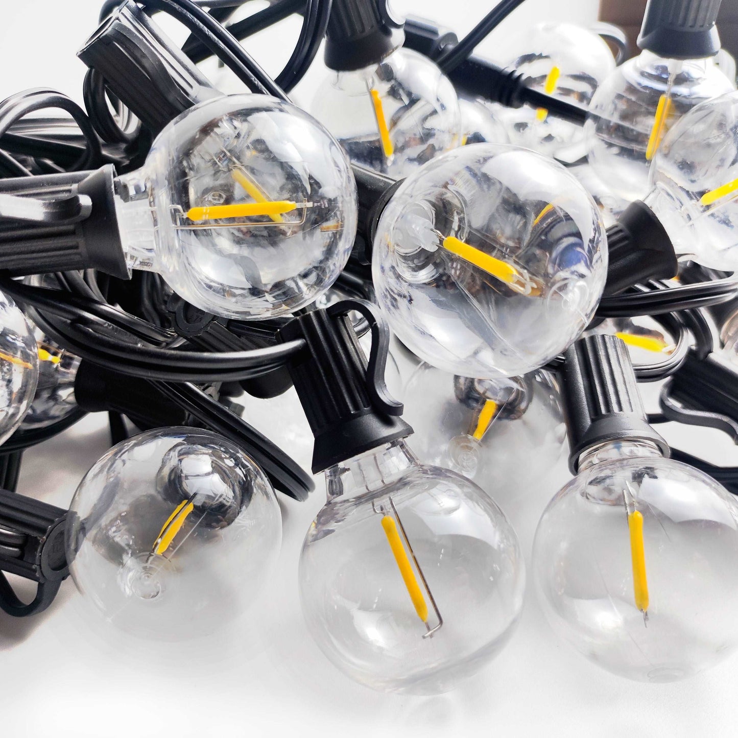 Close-up of clear bulb string outdoor solar lights with black wiring from Ningbo Fuaisi Electric Appliance