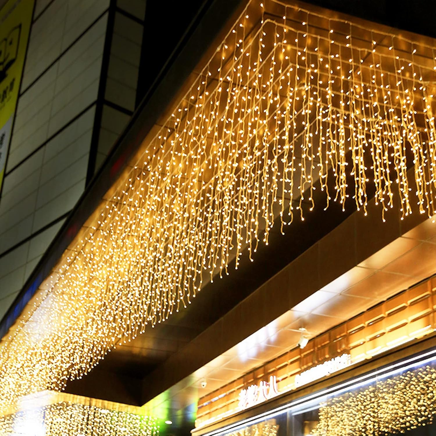Outdoor LED Fairy lights hanging in warm white from building eaves for decorative lighting