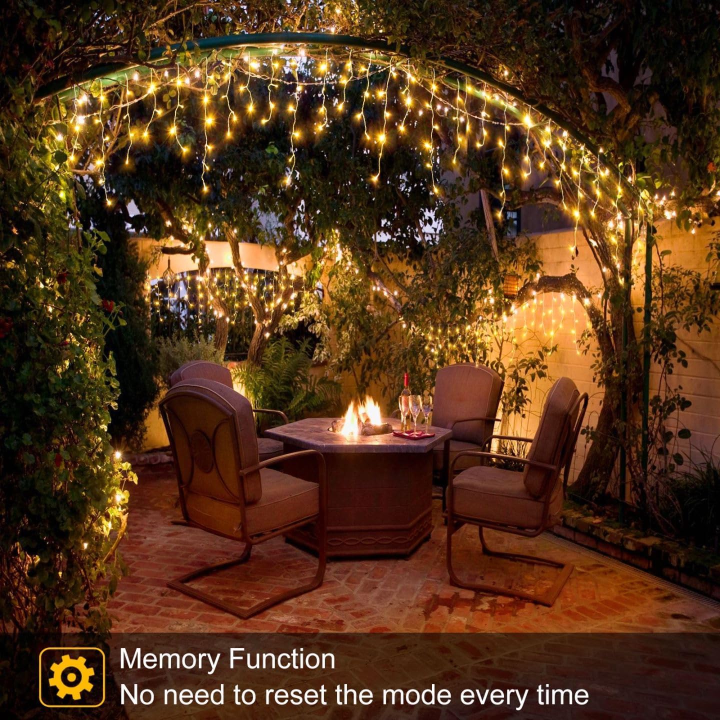Outdoor patio area illuminated with warm white LED Fairy lights hanging from a garden arch and trees