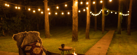 Cozy outdoor seating with string lights showcasing holiday LED lighting ideas in a backyard at night