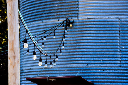 Example of how to connect LED string lights hanging outdoors on a blue corrugated metal wall